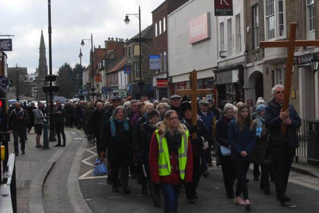 Dozens of Sleaford shoppers stopped to watch the procession following the cross.