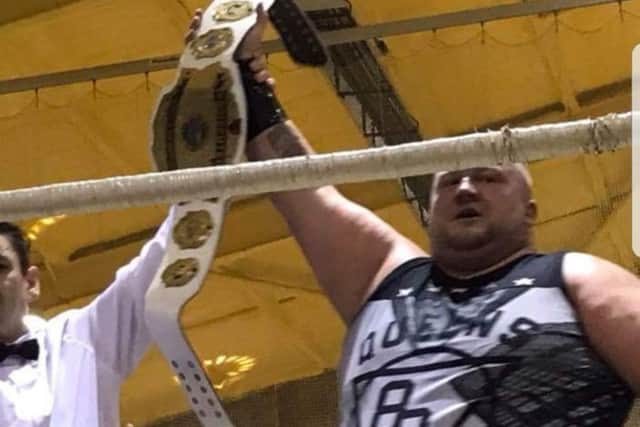 Dale has his arm raised by the referee.