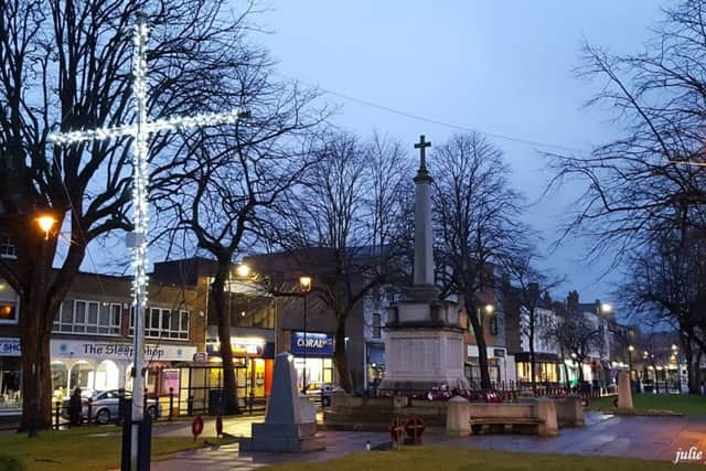 The fence around the Ingram Memorial and the flagpole behind Boston War Memorial was lit up by the Christmas in Boston Electricians for Easter weekend. Photo: Julie Perrot/Christmas in Boston Electricians
