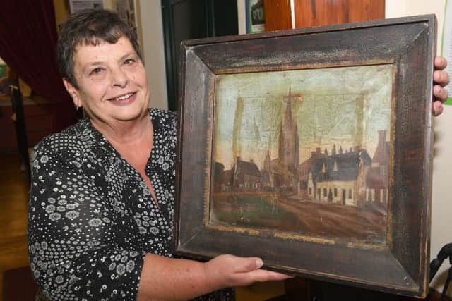 Helpringham History Society exhibition at Helprringham Village Hall. Secretary of history group Laraine Wright with a recently found painting. EMN-180204-090937001
