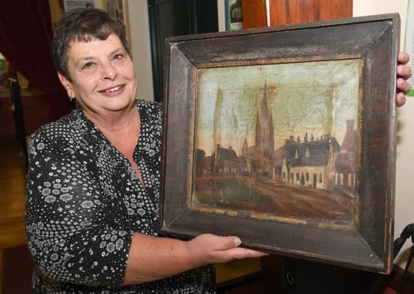 Helpringham History Society exhibition at Helprringham Village Hall. Secretary of history group Laraine Wright with a recently found painting. EMN-180204-090937001