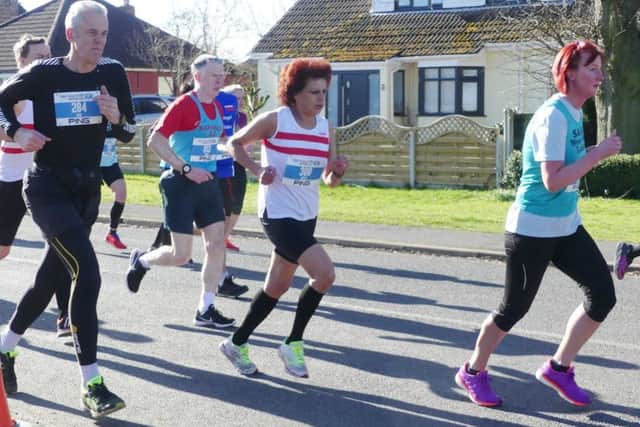 Betty Gash (red and white vest) won the vet 55 age group at the Gainsborough and Morton 10k EMN-180604-175402002