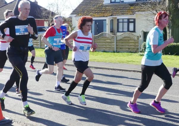 Betty Gash (red and white vest) won the vet 55 age group at the Gainsborough and Morton 10k EMN-180604-175402002
