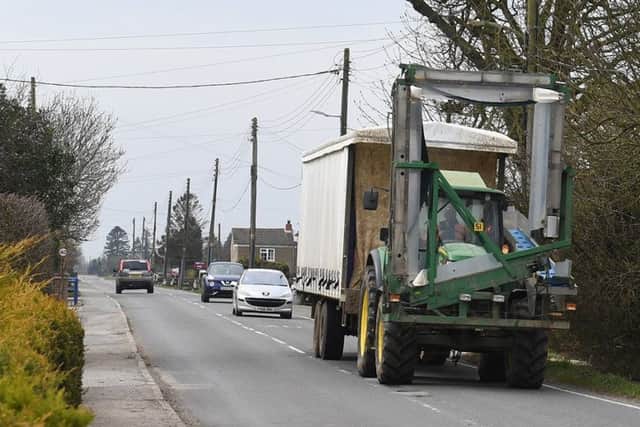 Haulage vehicles on the main road through Langrick. EMN-180904-093602001