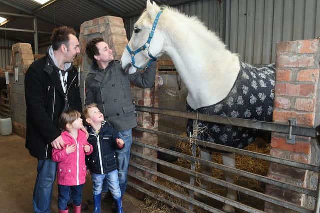 Matt Stevenson and Dan Stevenson with Leanna Stevenson, 3, and Jayden Stevenson, 4. pictured with Pluto. at the Easter Fun Day at Northcote Heavy Horse Centre. Photo: MSKP-010418-1 ANL-180904-113211001