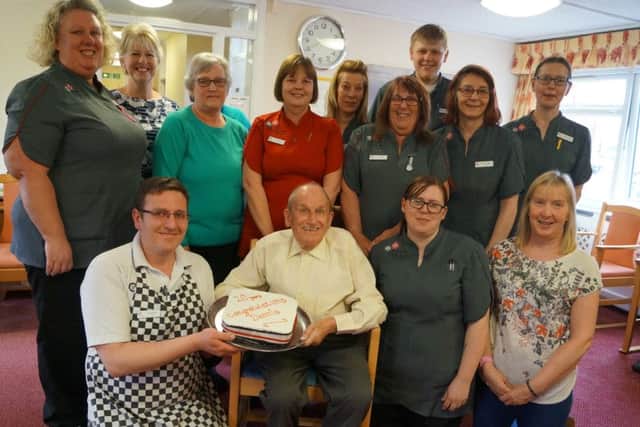 Dennis Cotton surrounded by staff members at The Poplars to mark his 20-years residency EMN-180904-172314001