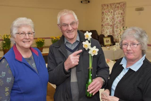 Judging the spring flowers and pointing out the finer points of a winning bloom is Bill Parrott of Waltham. Also pictured is Christine Raynor, chairman, and Lyn Small, club secretary.
Photo John Edwards. EMN-181204-153012001