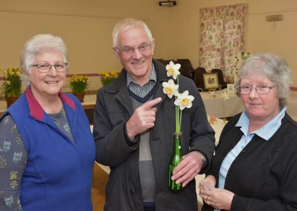 Judging the spring flowers and pointing out the finer points of a winning bloom is Bill Parrott of Waltham. Also pictured is Christine Raynor, chairman, and Lyn Small, club secretary.
Photo John Edwards. EMN-181204-153012001