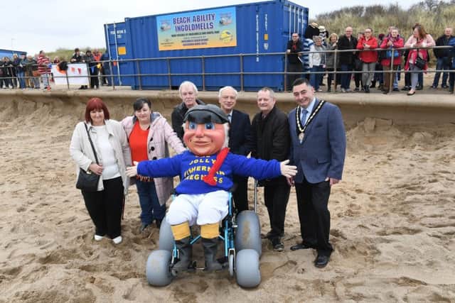 Launch of Beach Ability beach wheel chairs at Ingoldmells. Jolly Fisherman sits in the beach wheel chair with (from left) Sue Wright, Tess Price, Kev Wright, John Orgine - Ingoldmells parish councillor, Glen Price, and Danny Brookes - Mayor of Skegness. Photo: MSKP-140418-11 ANL-180416-121705001