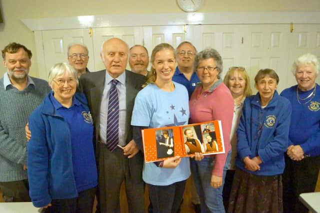Sara Sprague with members of the Lions EMN-180417-082654001