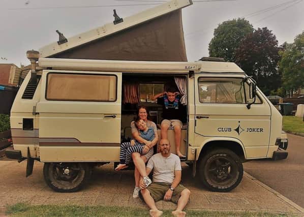 The family pictured with their camper van shortly before setting out on their adventure in July, 2017.