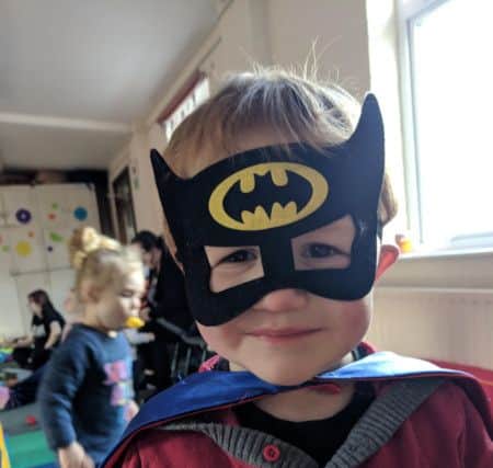 This cheeky little Batman loves sessions at Tiny Tots.