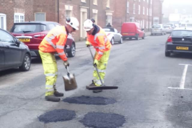 Potholes being repaired in West Street, Horncastle - just one day after the latest edition of the Horncastle News was published. EMN-181204-115740001