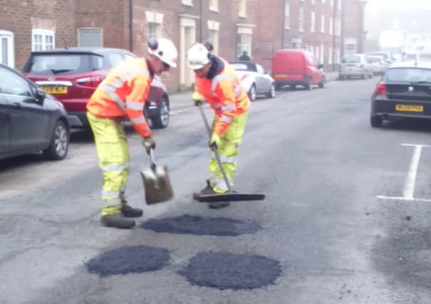 Potholes being repaired in West Street, Horncastle - just one day after the latest edition of the Horncastle News was published. EMN-181204-115740001