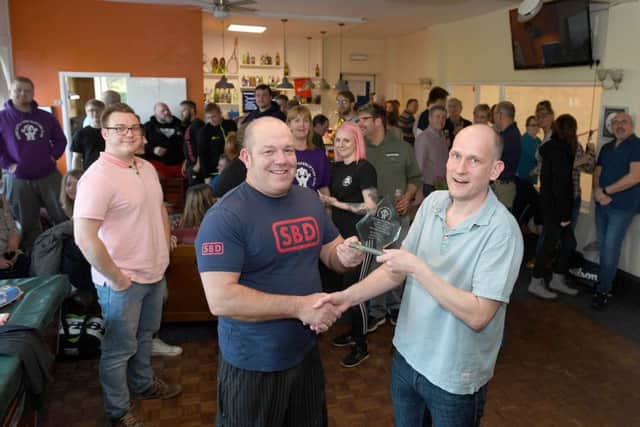 Horncastle Squash Club celebrating 10 years of being run by members. Chairman of the squash club Tim Verdon (right) presenting a gift to Mark Giles who runs the powerlifting club.
