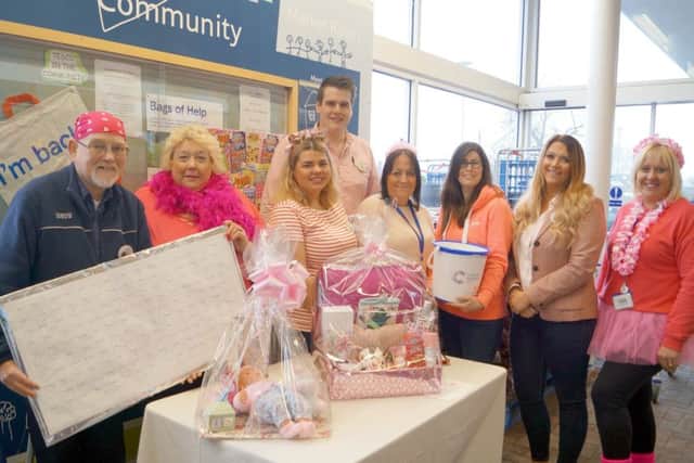 Tesco staff get in the pink for Cancer Research UK EMN-180415-190955001