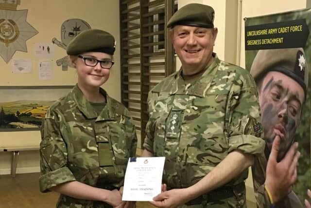 Cadet Chelsea Drayton receives her certificate from Col Field confirming the completion of her basic cadet training. ANL-180413-165709001