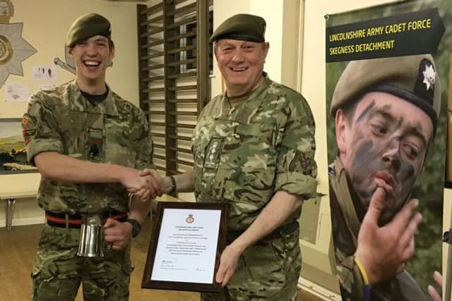 Cadet Regimental Sergeant Major Doveydas Vainoras receives his certificate of achievement and an engraved tankard from Col Field. ANL-180413-165726001