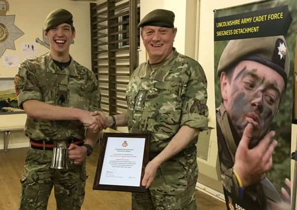Cadet Regimental Sergeant Major  Doveydas Vainoras receives his certificate of achievement and an engraved tankard from Col Field. ANL-180413-165726001