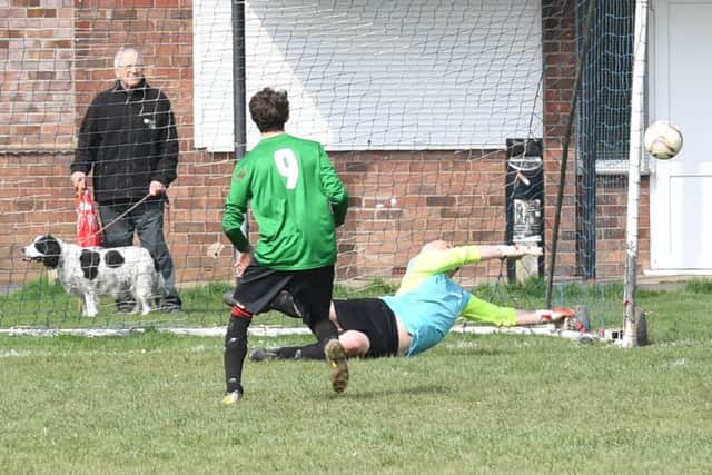 Fishtoft (blue) v Coningsby (green). Fishtoft's stand-in goalkeeper Darren Tate saving a penalty.