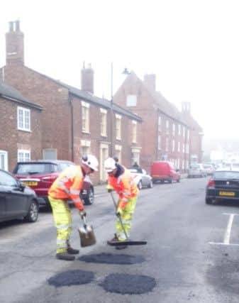 Potholes being repaired in West Street last week.