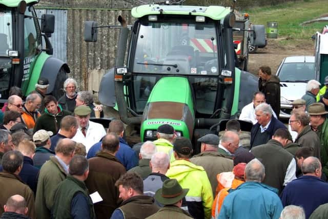 Crowds gather round one of the auction items. EMN-180416-154404001