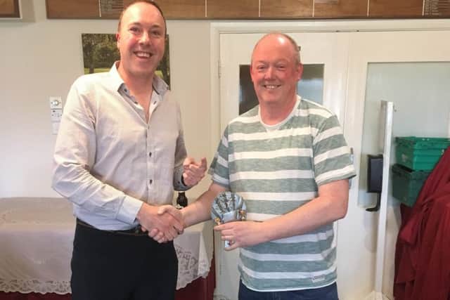 Rob Sutherland being presented with his trophy by Lawrence Cook EMN-180419-153143001