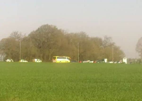 The back of the bus involved (right) alongside police vehicles and queueing traffic on the A16 at Grainsby.