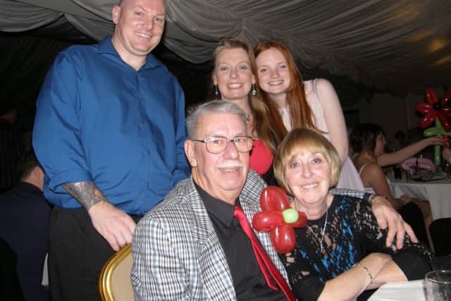 John White, his daughter Emma behind him and family. EMN-180420-143059001