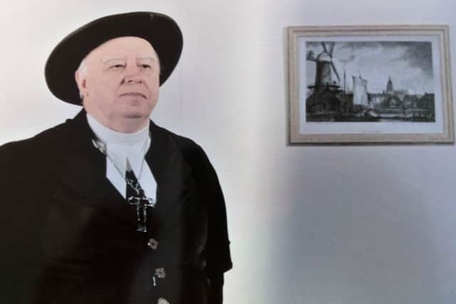 Alan Robey as Rev Waterston, who appears in the video linked to the plaque on the Town Hall. EMN-180420-171031001