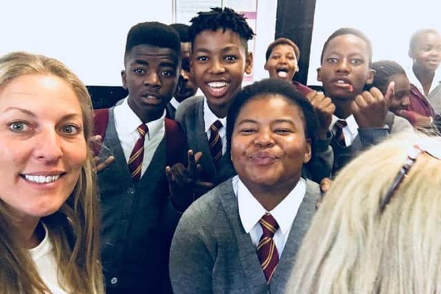 An inspiring experience. Emma has fun with pupils at a Capetown school visit. EMN-180105-141347001