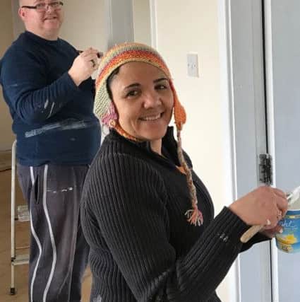 Louis Mullaney and Andrea Fletcher helping paint the new office zone