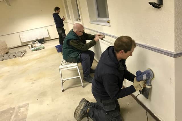 Martin Forsythe and other volunteers working on the main meeting room.