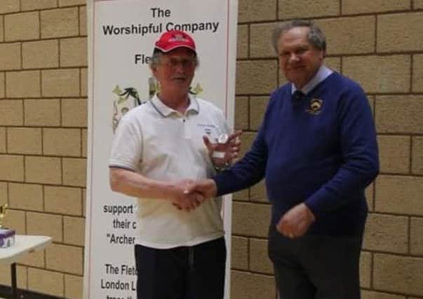 Pete Shaw receives his winners' trophy from Chris Brown, chairman of The Worshipful Company of Fletchers Trust EMN-180427-120552002