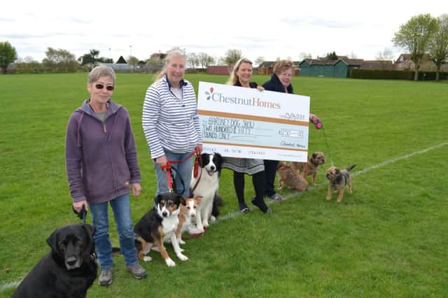 Stephanie Tilley from Chestnut Homes presents the organisers of the Bardney Dog Show with a donation.