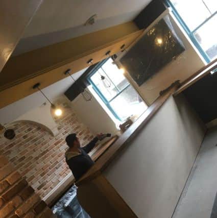 Greg Darmon hard at work preparing for Friday's opening of the Grapes. EMN-180105-165724001