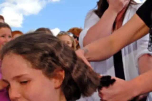 Amber is preparing to have her hair cut for the second time. Here she is back in 2012 getting the chop. Picture: John Aron. EMN-180305-155543001