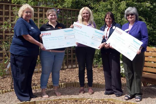 Representatives from Market Rasen Junior Band, Happy Hooves Equestrian Learning and Rase Heritage Society collect their cheques EMN-180515-122549001