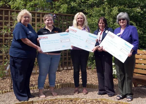 Representatives from Market Rasen Junior Band, Happy Hooves Equestrian Learning and Rase Heritage Society collect their cheques  EMN-180515-122549001