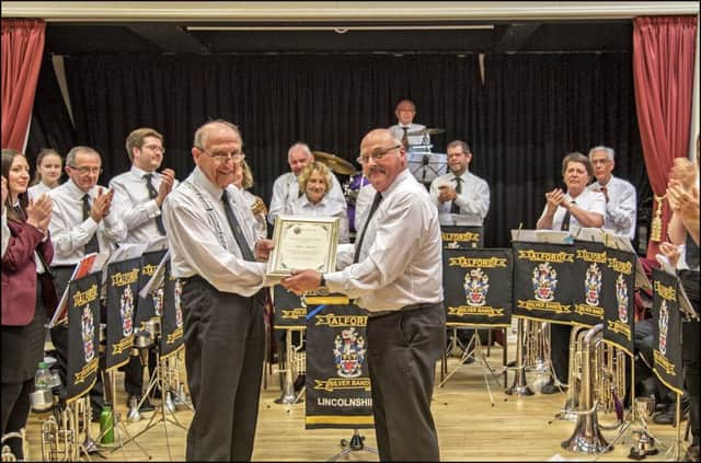 The band joins in the applause as Alan White receives his certificate.
