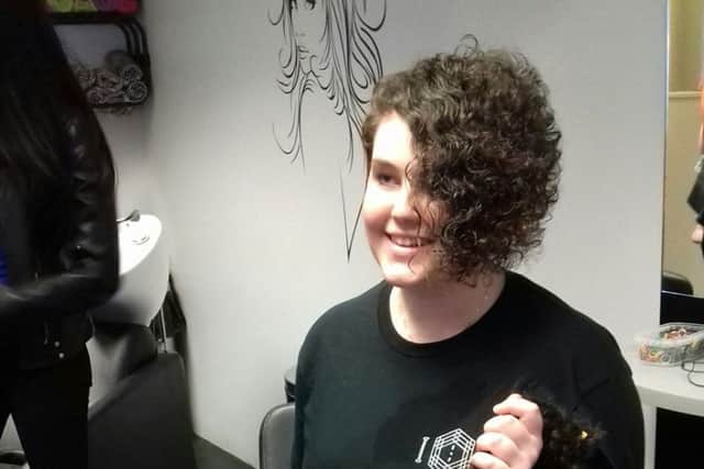 All smiles as Amber approves of her shorter hairstyle. EMN-181005-114506001