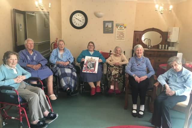 Oakdene residents with their wedding congratulations card for Meghan and Harry. From left - Mary Graves, Annie Young, Joyce Moyses, Kathleen Olsen, Gladys Harrison, Joyce Dodsworth and Brenda Smith. EMN-180514-163801001