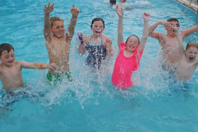 Youngsters have a splash on the first day of the 2018 open season at Metheringham Swimming Pool. EMN-180515-094712001