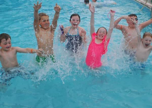 Youngsters have a splash on the first day of the 2018 open season at Metheringham Swimming Pool. EMN-180515-094712001