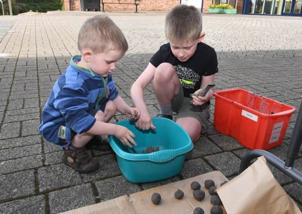 Drop-in seed bomb making workshop at The National Centre for Craft and Design. Perry Cook 3 and Ewan Cook 7 of Sleaford making seed bombs. EMN-180514-105106001