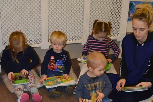 Pictured are some of the pupils at the pre-school enjoying the new books.