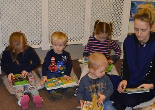 Pictured are some of the pupils at the pre-school enjoying the new books.