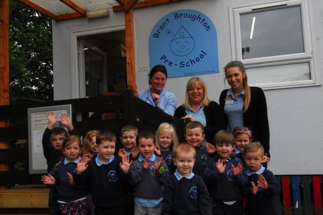 Brant Broughton Pre-School children celebrate a good Ofsted inspection rating with, from left - Michelle O'Reilly - deputy manager, Sally Harper - manager and Emily Harper - Pre-school Practitioner. EMN-180520-104359001