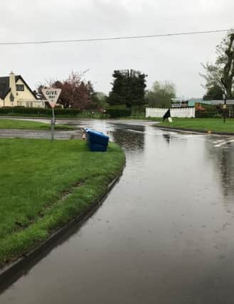 Flooding in Kirkby on Bain as the pond overflows. EMN-180521-110722001