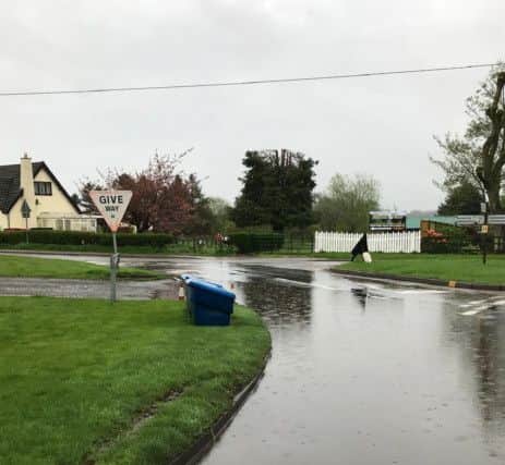Flooding in Kirkby on Bain as the pond overflows. EMN-180521-110722001